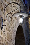 Large outdoor wall lamp with curved arm in patinated brass. Aldo Bernardi. 