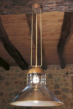 Double pendant lamp in patinated brass and clear glass conical hemispherical reflectors. Aldo Bernardi. 