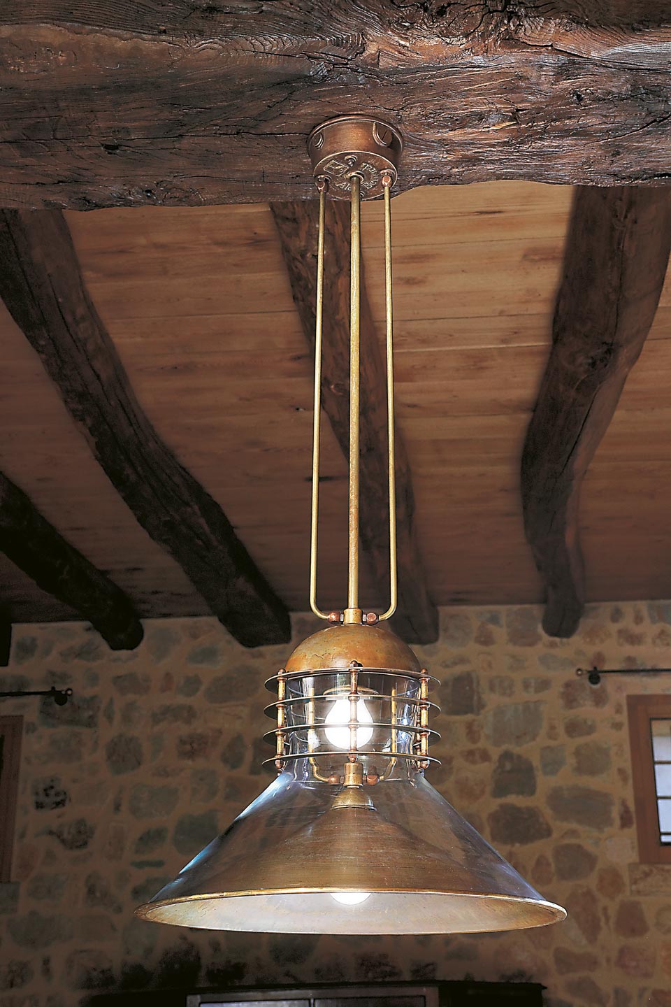 Double pendant lamp in patinated brass and clear glass conical hemispherical reflectors. Aldo Bernardi. 