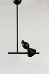 Black metal pendant lamp Alouette on its branch. Atelier Areti. 