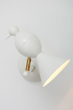 Alouette design white wall light to the left. Atelier Areti. 