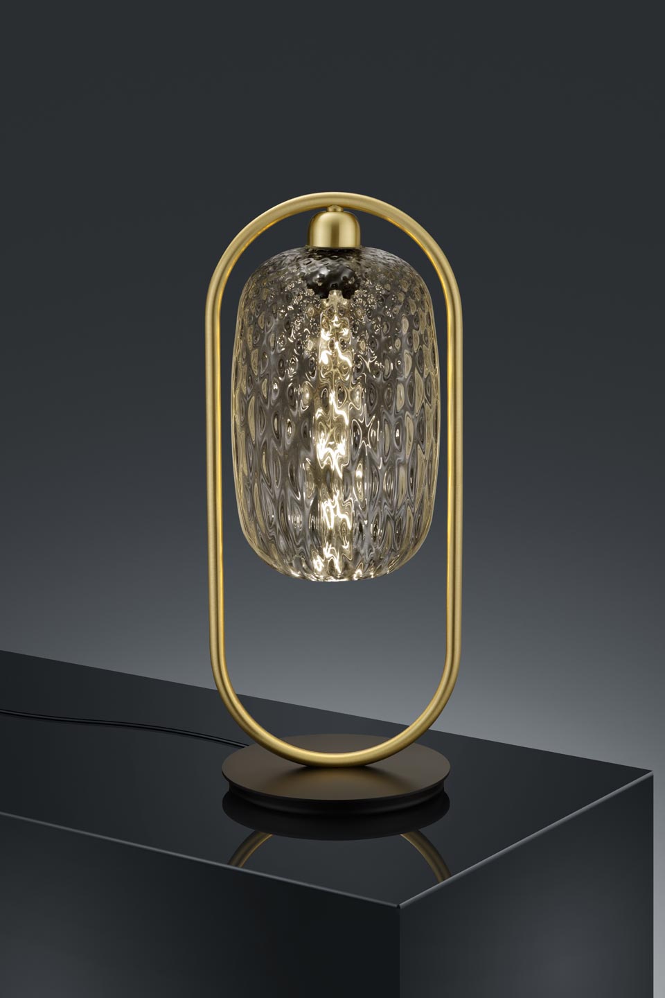 Design golden table lamp and transparent glass. Baulmann Leuchten. 