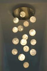 Constellation 16 moons chandelier en japanese paper. Céline Wright. Constellation 16 moons chandelier en japanese paper. Céline Wright.