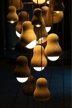 Small designer pendant light, in cork, peanut shape. Dark. 