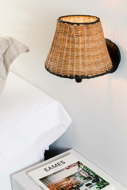 Sumba bedside wall lamp in natural rattan. Faro. 