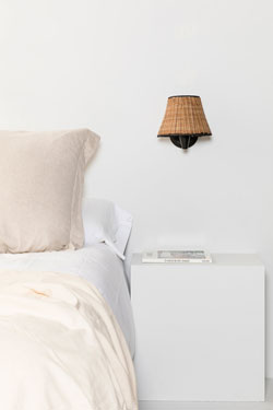 Sumba bedside wall lamp in natural rattan. Faro. 