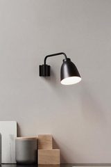 Black Caravaggio wall lamp. Fritz Hansen. Black Caravaggio wall lamp. Fritz Hansen.