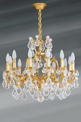 Lustre à pampilles Louis XV doré cristal de bohème douze lumières. Lucien Gau. Lustre à pampilles Louis XV doré cristal de bohème douze lumières. Lucien Gau.