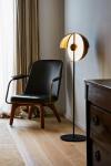 Theia floor lamp, LED lighting and half-shell shade with dimmer switch in black metal. Marset. 