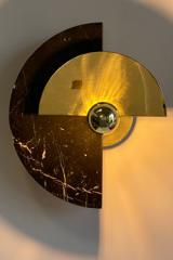 Round adjustable sconce in polished brass and black marble. Matlight. 