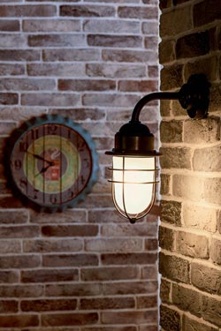 Storm exterior wall light in aged brass curved rod. Moretti Luce. 