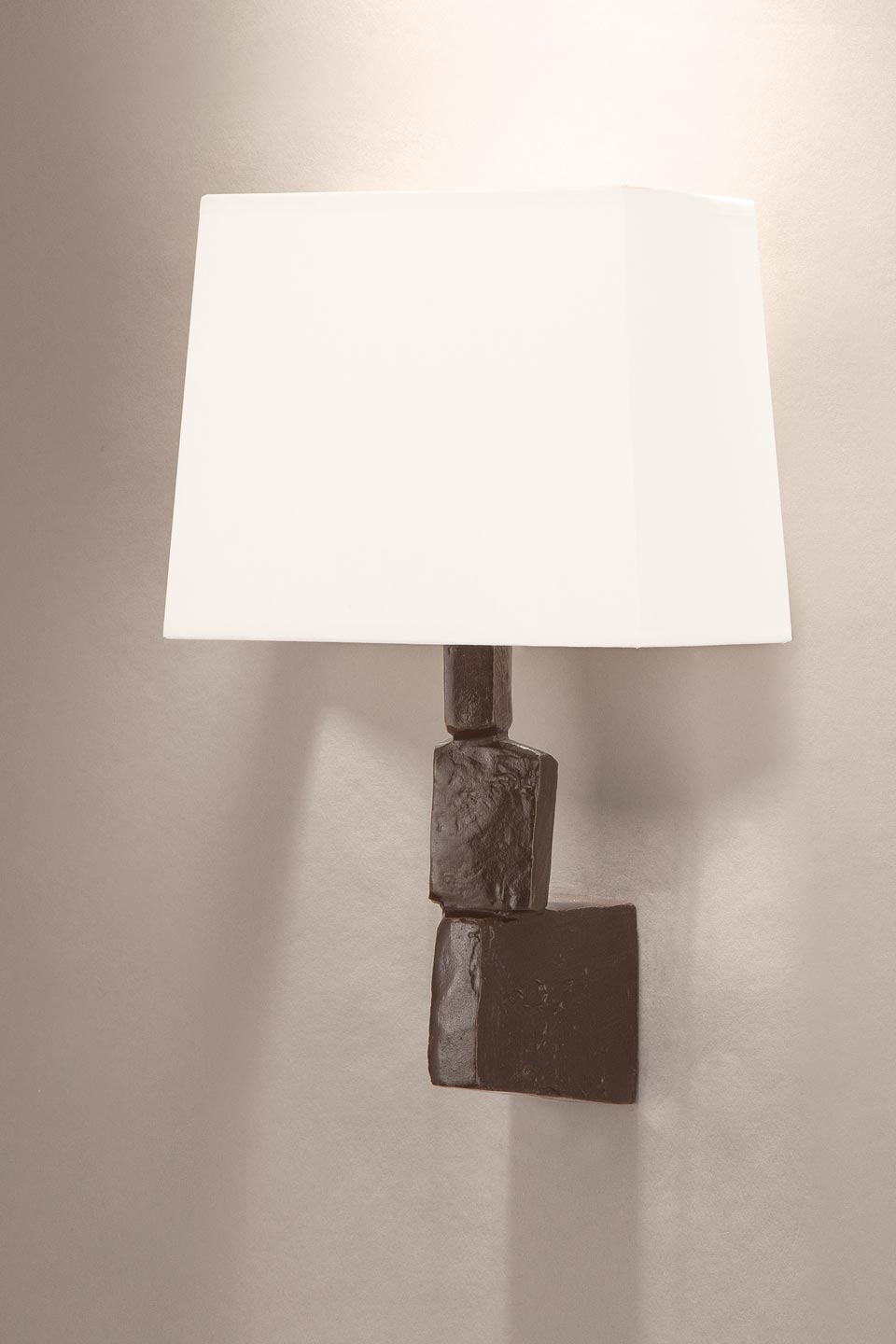 Fragile wall light with stack of stones in patinated black bronze. Objet insolite. 